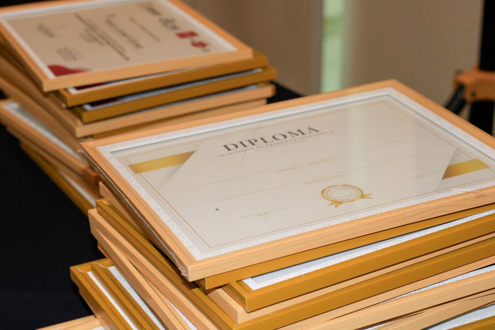 Stack of framed diplomas, like the certificates earned through cruise travel agent certification