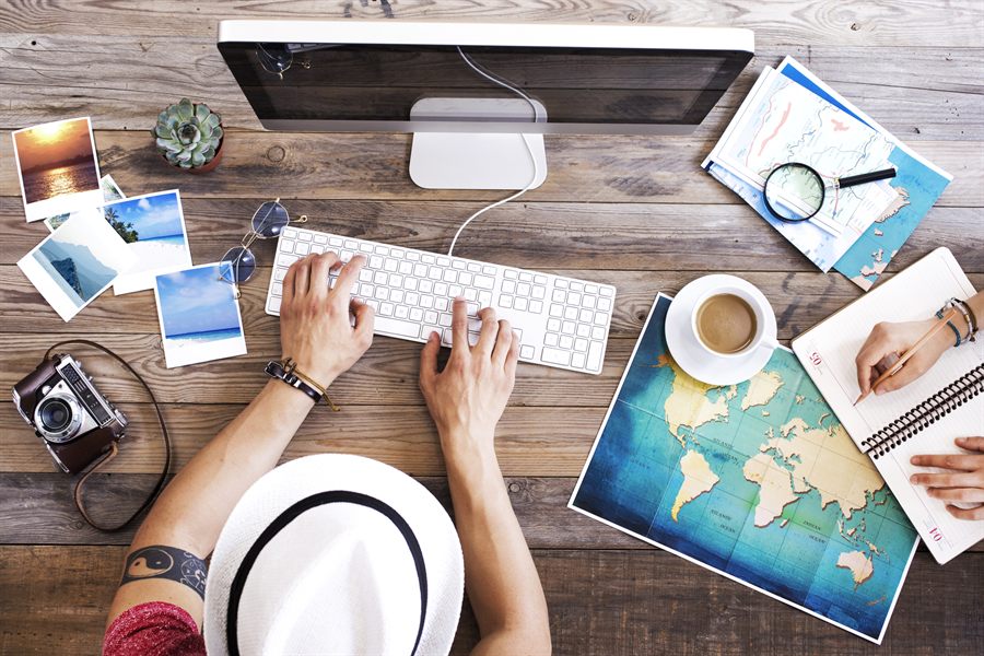 Desk with keyboard, maps and photos from above